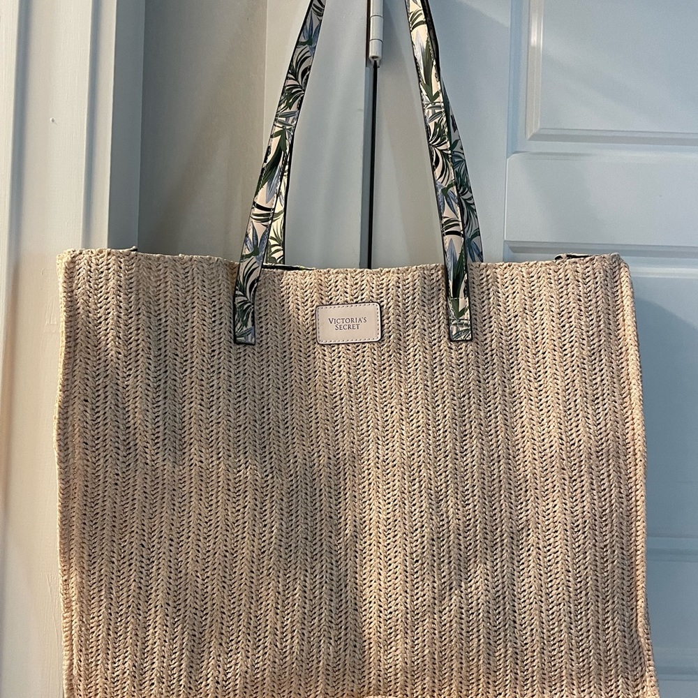 Victoria secret woven lined beach tote. New without tags. Snap open and close.